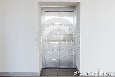 Metal elevator lift door dark hallway Stock Photo