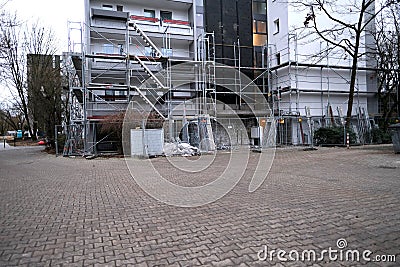 Metal erection scaffolding, construction site with materials for the repair of buildings in the city, concept of renovation of the Editorial Stock Photo