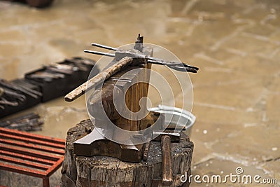 A metal fabricator utilizing a torch to heat up a piece of metal in order to shape it utilizing a forging technique Stock Photo