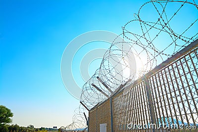 Metal fence with barbwire Stock Photo