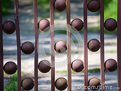 A metal fence made of square profiles, connected by round washers. Stock Photo