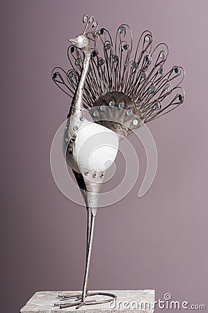 Metal figurine peacock on a pedestal Stock Photo