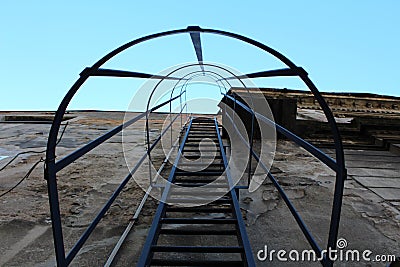 Metal fire escape stairs with round safety tunnel Stock Photo