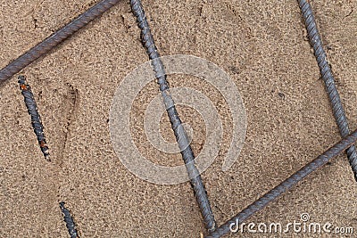 The metal fittings laid in sand. Preparation for pouring concrete. Selection focus. Shallow depth of field Stock Photo