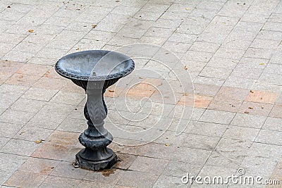 Metal fountain in city. Drinking metal fountain with no water wi Stock Photo