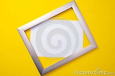 Metal frame with a white background lies on a yellow background Stock Photo