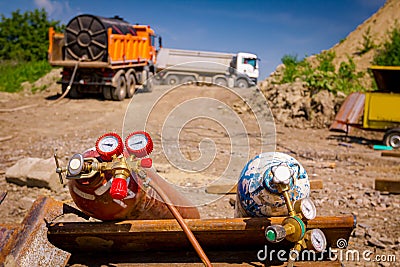 Metal gas acetylene cylinder containers with oxygen and nitrogen placed on the construction site Editorial Stock Photo