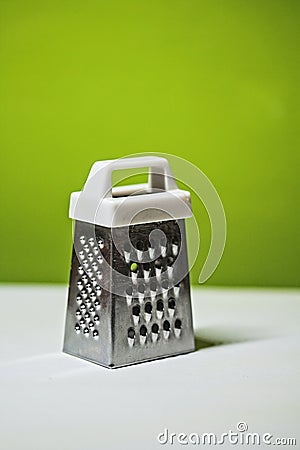 Metal grater with plastic white handle Stock Photo