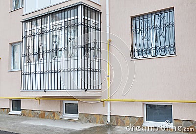 Metal grid for windows and balcony protection. House balcony window with iron security bars. Stock Photo