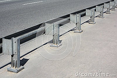 Metal guardrail on an asphalt bridge Stock Photo