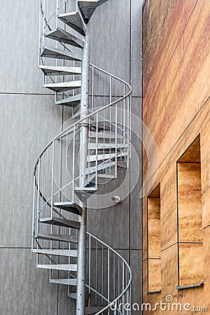 Metal, industrial spiral staircase. Emergency and fire exit Stock Photo