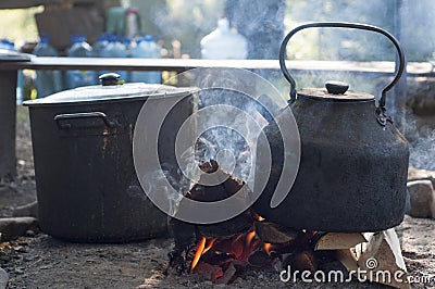 Metal kettle boiling on the fire Stock Photo