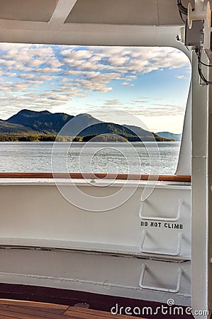 Metal ladder rungs on cruise ship deck with view of mountain scenery in background ner Ketchikan, Alaska. Stock Photo