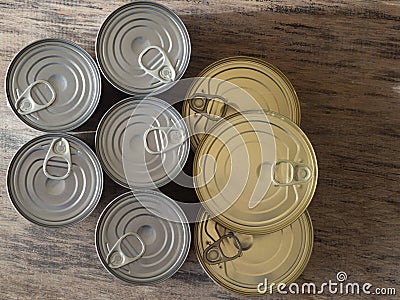 Metal, large food cans with an extended shelf life - canned food, standing on a wooden rustic table Stock Photo