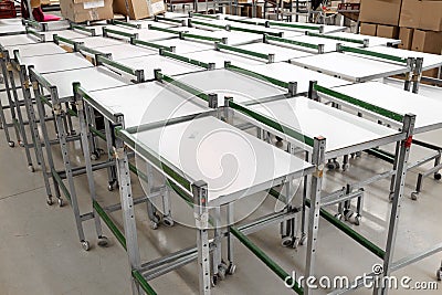 Metal legs with swivel wheels of empty industrial factory materials roller trolley close up shot top view Stock Photo