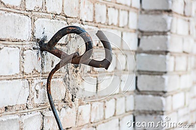 Metal loop in the brick wall Stock Photo