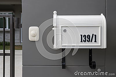 Metal mailbox and modern concrete dark grey wall for background. Stock Photo