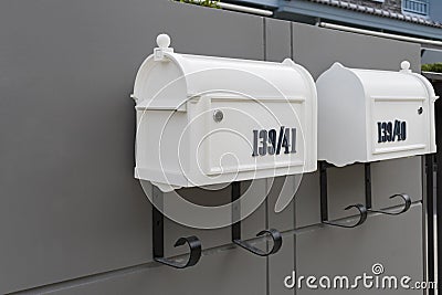 Metal mailbox and modern concrete dark grey wall for background. Stock Photo