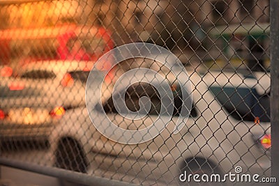 Metal net fence view on sun light traffic jam background Stock Photo