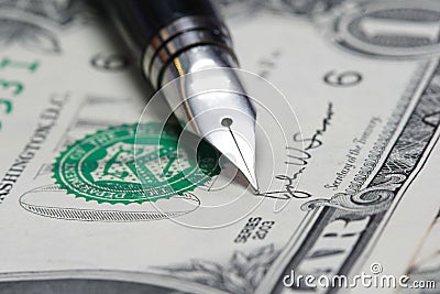 Metal Nib Pen on dollar bill Stock Photo