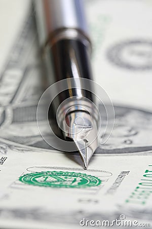 Metal Nib Pen on dollar bill Stock Photo