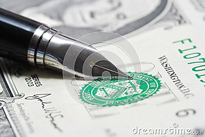 Metal Nib Pen on dollar bill Stock Photo