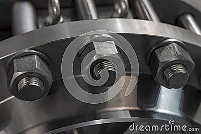 Metal nuts attract flange studs. Close up. Stock Photo