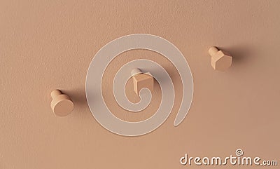 Metal orange hangers in forms of circle and square and hexagon on colorful wall in studio Stock Photo