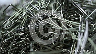 Metal paper clips stacked up extreme closeup, office supplies, unorganized group Stock Photo