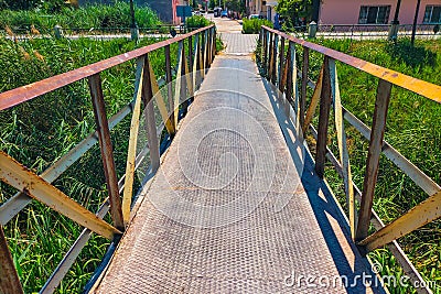 A metal pedestrian bridge connecting the two sides Stock Photo