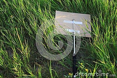 Metal periscope baton of protest activists thrown in bushes or tall grass Stock Photo