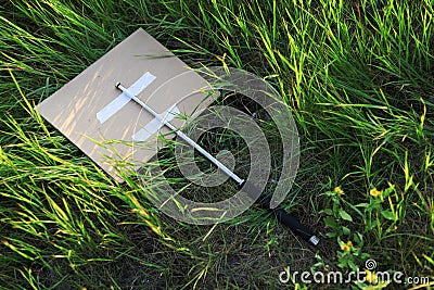 Metal periscope baton of protest activists thrown in bushes or tall grass Stock Photo