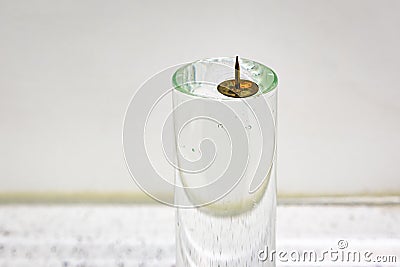 A metal pin floating on water Stock Photo