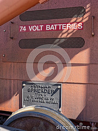 The metal plaque and battery compartment of an historic Jordan Type A Spreader at the rail yard in Oakridge, Oregon, USA Editorial Stock Photo