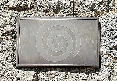 Metal Plaque on Stone Wall Stock Photo