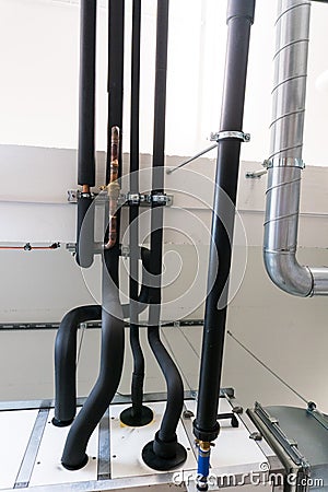 Metal and plastic pipe system on the cellar ceiling of an apartment building Stock Photo