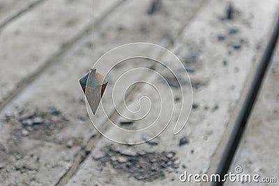 metal plumb line used in construction site Stock Photo