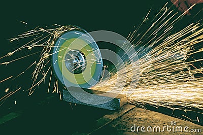 Metal processing by manual action grinding machine with flying sparks Stock Photo