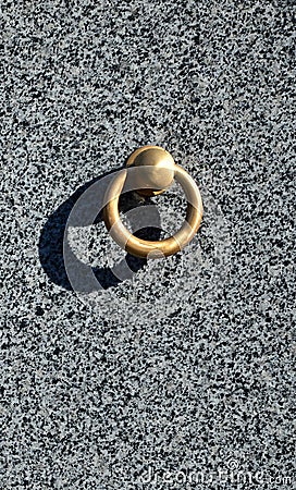 Metal ring on grave of cemetery. Rusty iron handle on granite tomb cover. An 19th century antique cemetery in Lvi Stock Photo