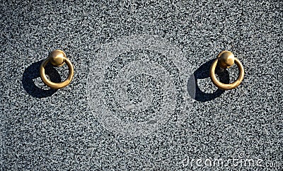 Metal ring on grave of cemetery. Rusty iron handle on granite tomb cover. An 19th century antique cemetery in Lvi Stock Photo