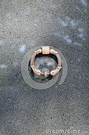 Metal ring on grave of cemetery. Rusty iron handle on granite tomb cover. An 19th century antique cemetery in Lvi Stock Photo
