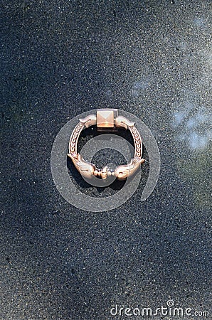 Metal ring on grave of cemetery. Rusty iron handle on granite tomb cover. An 19th century antique cemetery in Lvi Stock Photo