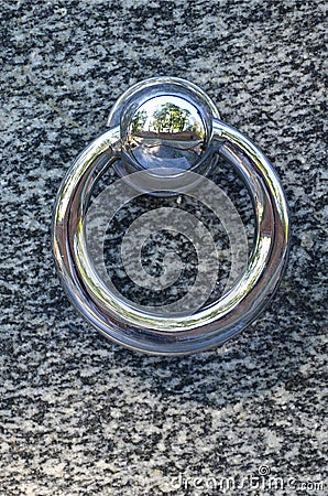 Metal ring on grave of cemetery. Rusty iron handle on granite tomb cover. An 19th century antique cemetery in Lvi Stock Photo