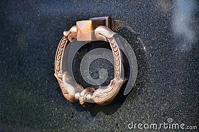 Metal ring on grave of cemetery. Rusty iron handle on granite tomb cover. An 19th century antique cemetery in Lvi Stock Photo