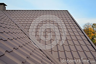 Metal Roof Construction Against Blue Sky. Roofing materials. Metal House roof. Closeup House Construction Building Materials. Stock Photo