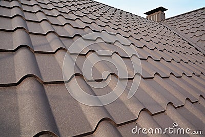 Metal Roof Construction Against Blue Sky. Roofing materials. Metal House roof. Closeup House Construction Building Materials. Stock Photo