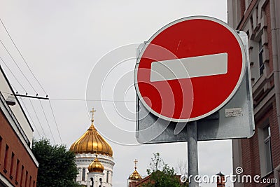 Metal round red road stop sign with white stripe in the background of golden dome of orthodox church Editorial Stock Photo