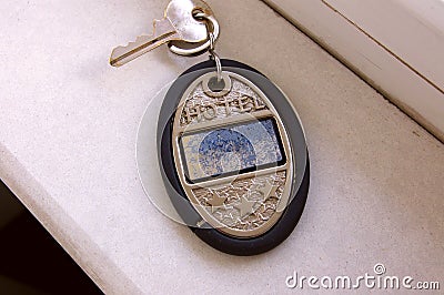 Metal and rubber key chain of a three star hotel. Metallic key rings of a hotel with three stars engraved on a silver Stock Photo