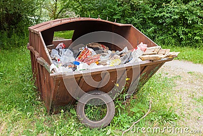 Metal rusty dumpster full of garbage Editorial Stock Photo