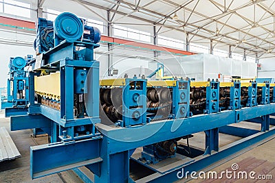 Metal sheet profiling factory. New modern roll forming machine Stock Photo